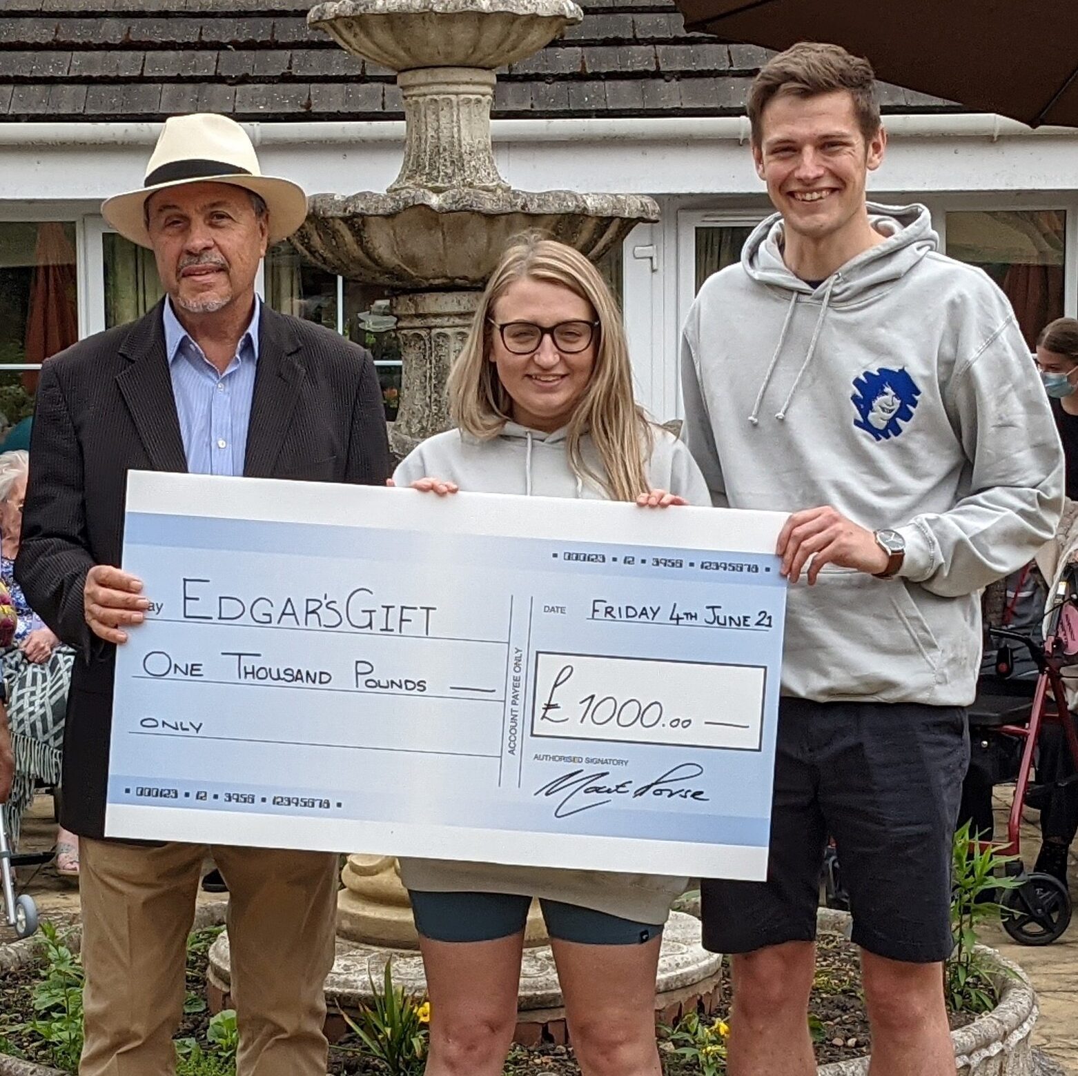 Moat House care home proudly present a cheque to Edgar’s gift