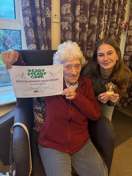 Bowood Court Resident Holding Certificate for "Best for Resident Involvement" in Ready Steady Cook Competition